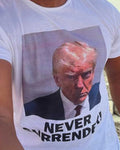 WHITE Our Trump Mugshot "Never Surrender" Short-Sleeve T Shirt is available in size M-XXXXL. We offer fast shipping and handle each order with care. #Trump #Mugshot #NeverSurrender #TShirt 