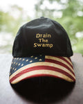 Show them how you feel wearing this DRAIN THE SWAMP embroidered in gold on the front. Available in Black with American Flag design bill and adjustable fabric strap in the back. #DrainTheSwamp 