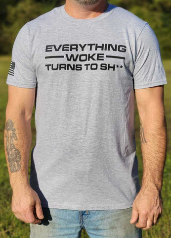This "Everything Woke Turns to Sh**" short-sleeve, crew-neck T Shirt has an American flag in black on the right sleeve. Available in Grey. Size M-XXXXL.