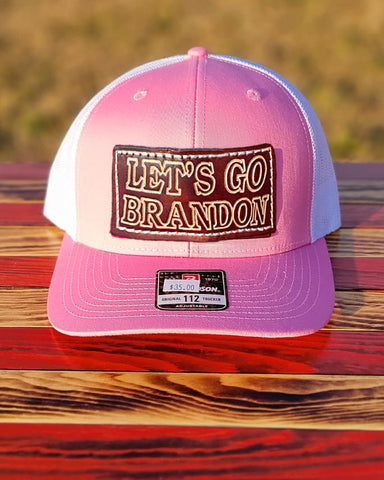 Rock our Trucker-Style Let's Go Brandon Leather Patch Hat with white mesh back.  The leather patch is custom made, hand-cut, and hand-stamped in the USA. Available in Pink + 2 other colors (see Red and Orange). 