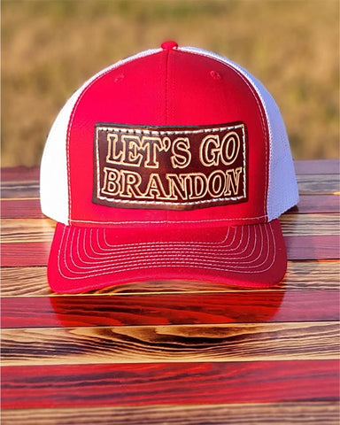 Trucker-Style Let's Go Brandon Leather Patch Hat with white mesh back.  The leather patch is custom made, hand-cut, and hand-stamped in the USA. Available in Red + 2 other colors (see Orange, and Pink).