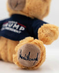 This patriotic teddy bear sports a navy blue Trump t-shirt, a red USA hat, and Donald Trump's signature stitched into the foot. This cutie measures 8" tall and 5" wide.
