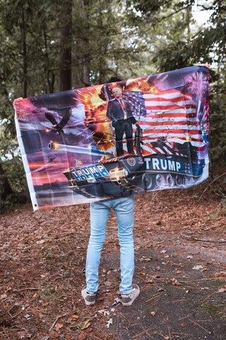 Trump "Boom" Flag, Trump Novelty Banner - Trump atop a Tank in front of an American Flag with BOOMS going off in the background.